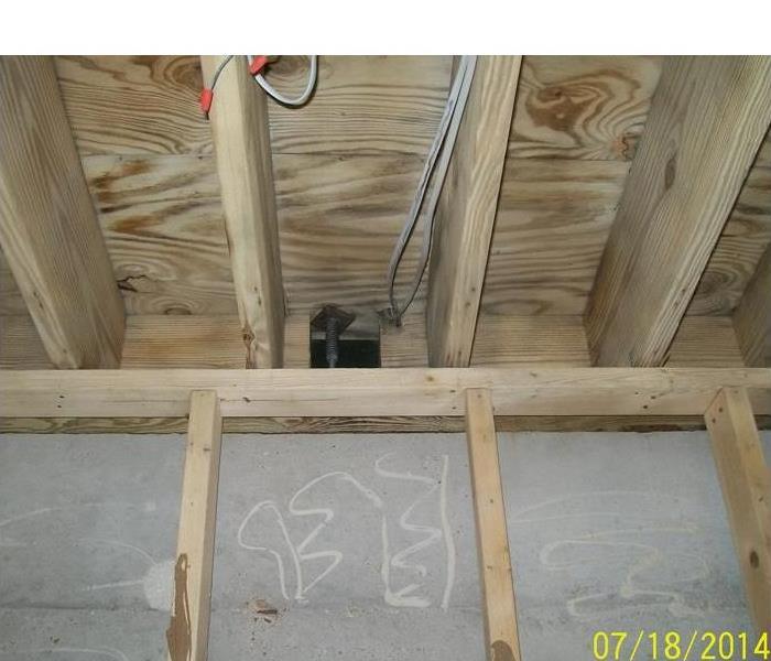 exposed wood trusses and cement wall