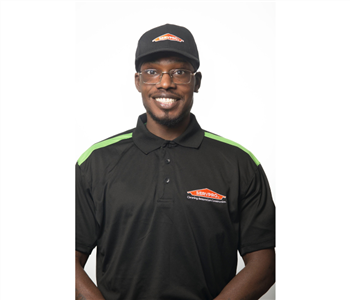 male, black servpro shirt, hat, glasses